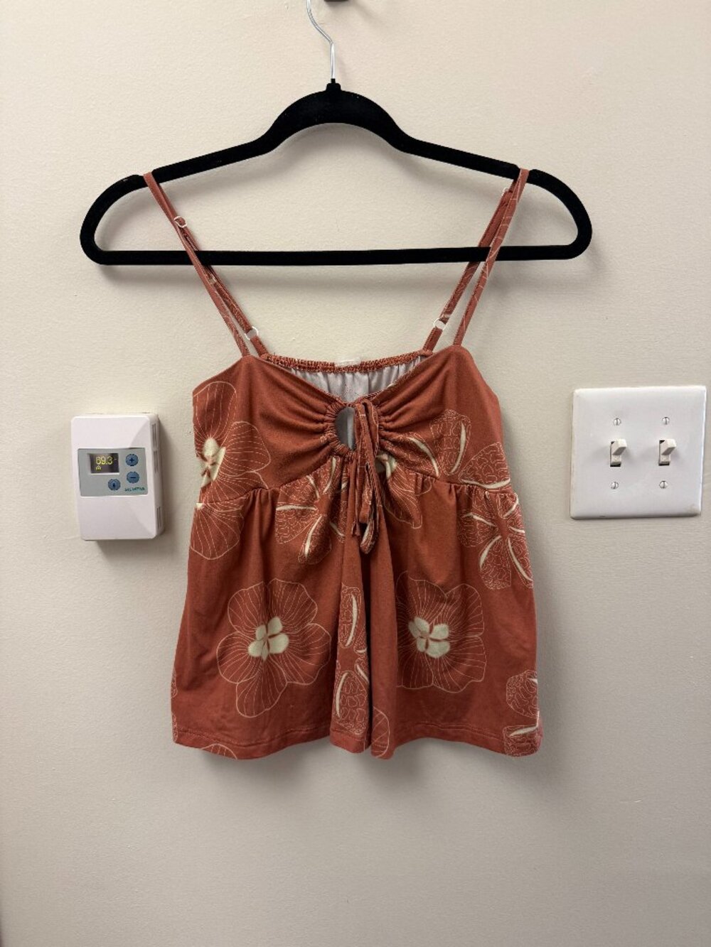 orange/brown top with white flower pattern